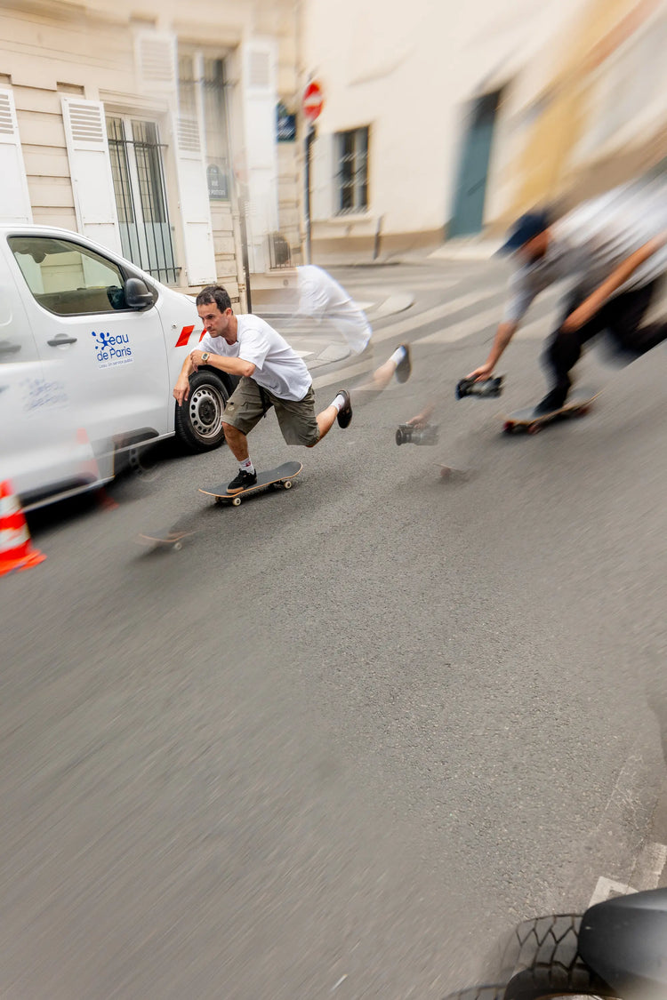 Man skateboarding in Paris while a videographer follows closely behind