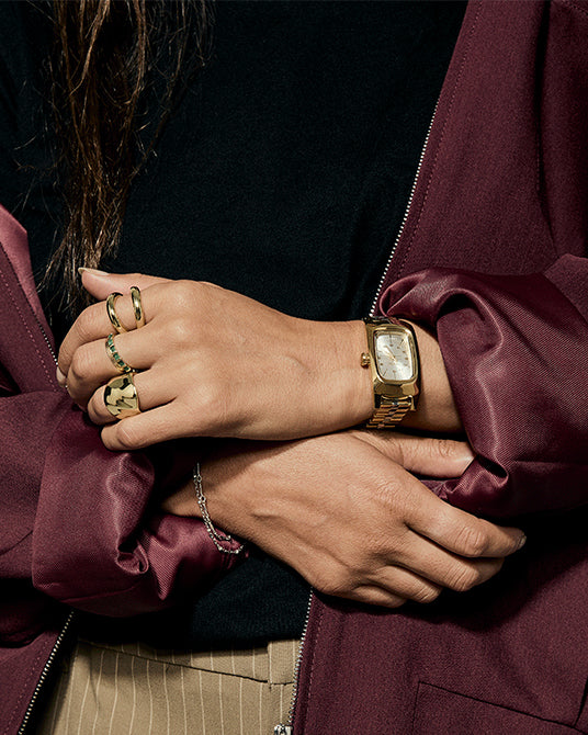 Woman wearing the gold and silver version of the Nixon Frankie watch