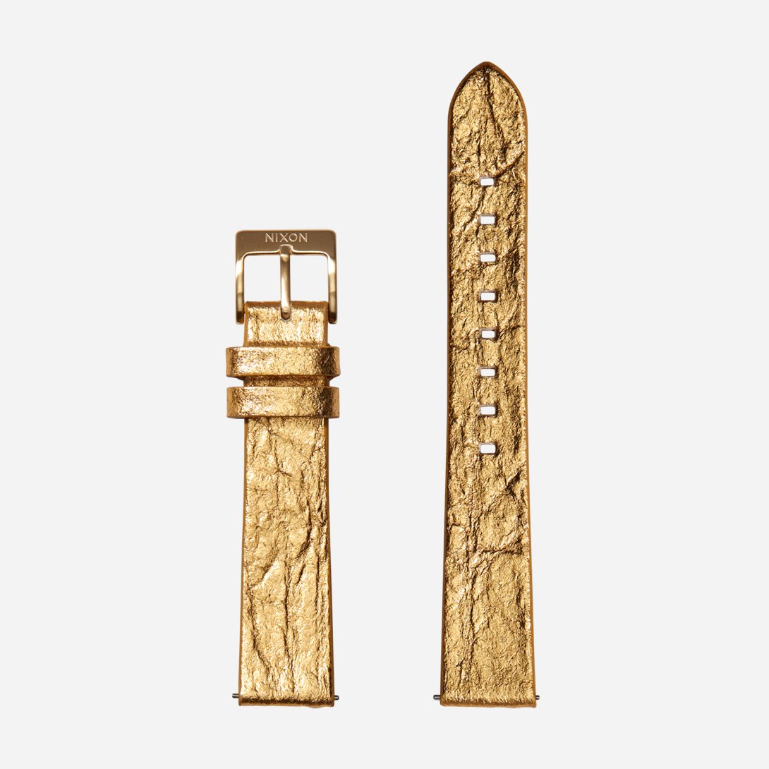 A sustainable gold Nixon watch band made from recycled or plant-based materials.